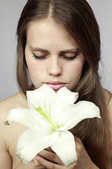 girl smells a lily