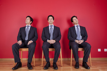 Three twin businessman waiting