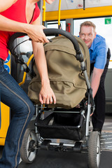 Woman with stroller getting into a bus © Kzenon