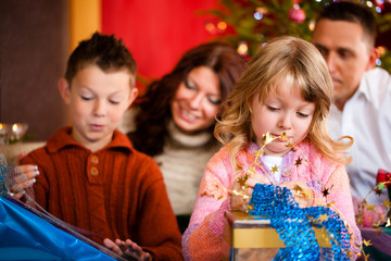 Fototapeta premium Christmas - family with gifts on Xmas Eve