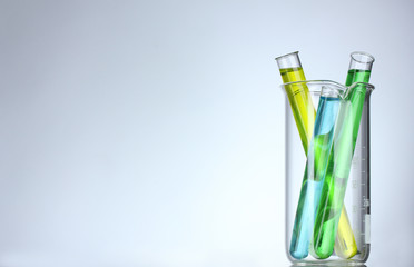 Test-tubes with liquid on gray background