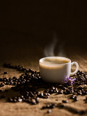 warm cup of coffee on brown background