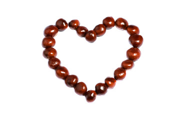 symbol heart made of chestnuts on white background