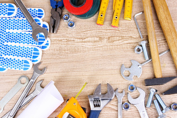 Construction tools on wooden background