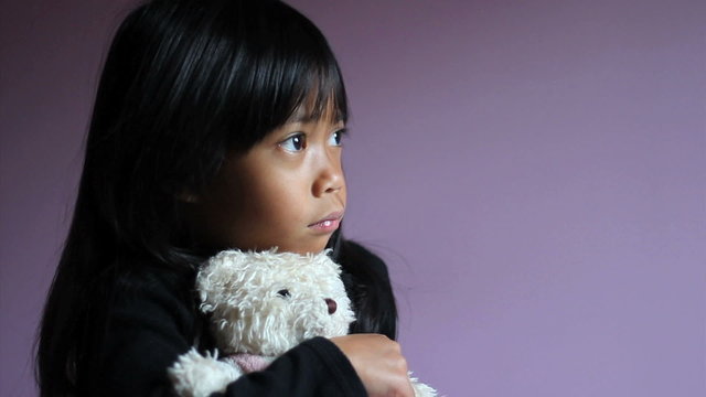 Sad Little Girl Hugging Teddy Bear