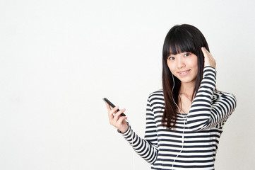 Fototapeta premium pretty asian woman listening music