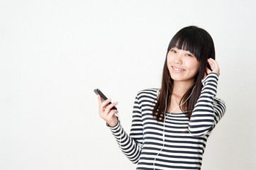 Fototapeta premium pretty asian woman listening music
