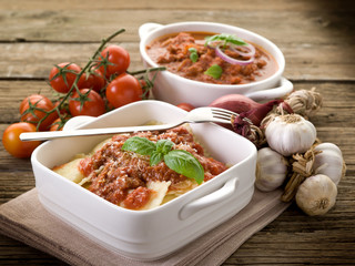 ravioli with ragout sauce on wooden table