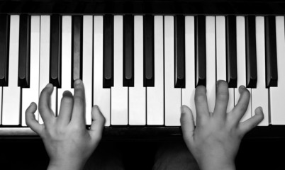 Hands on piano keyboard