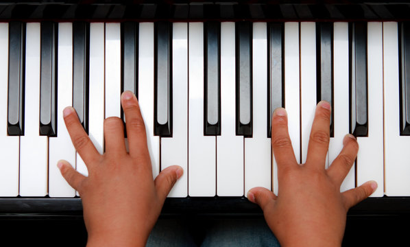 Hands on piano keyboard