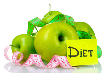 ripe green apples and measuring tape isolated on white
