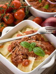 ravioli with ragout sauce on wooden table
