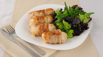 Chicken rolls stuffed with cheese wrapped in bacon