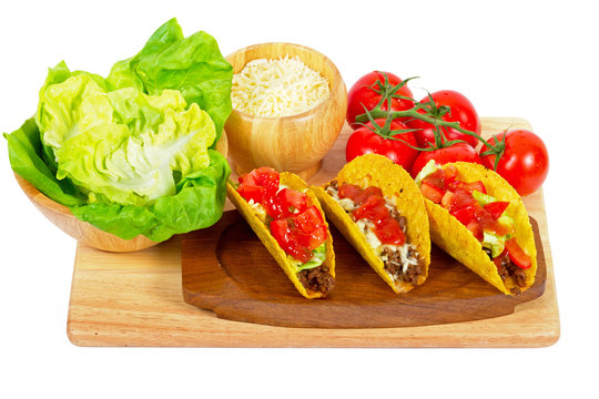 Mexican burrito in tortilla shells with fresh tomatoes.