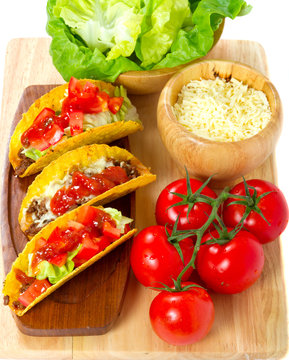 Mexican burrito in tortilla shells with fresh tomatoes.