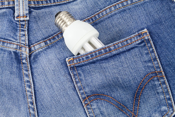 Energy saving light bulb comming out of jeans pocket