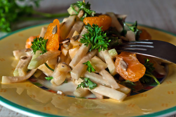 Kohlrabi salad on white wooden table