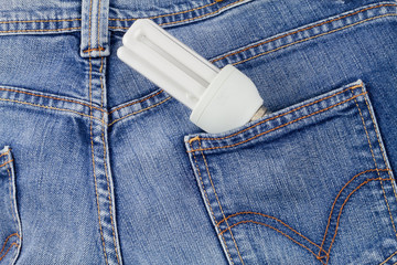 Jeans back pocket with energy saving light bulb