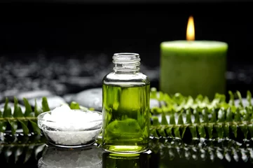 Gordijnen essential oil and fern with spa salt in bowl and burning candle © Mee Ting