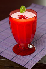 a red currant milkshake in red glass