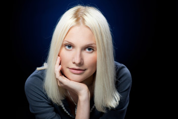 Fototapeta premium Portrait of young pensive female looking at camera