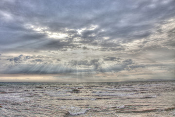 Sun Beams across Clouds over the Sea