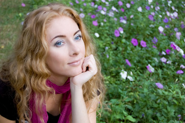 Naklejka premium Woman among violet flowers