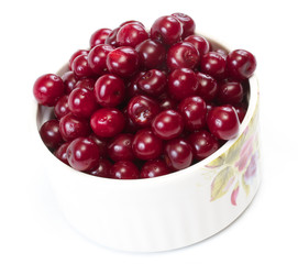 Bowl with ripe cherries. Isolated on a white background.