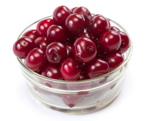 Bowl with ripe cherries. Isolated on a white background.