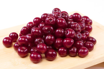 Bowl with ripe cherries. Isolated on a white background.