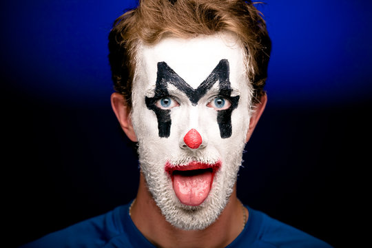 A man with clown makeup on his face