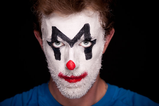 A man with clown makeup on his face