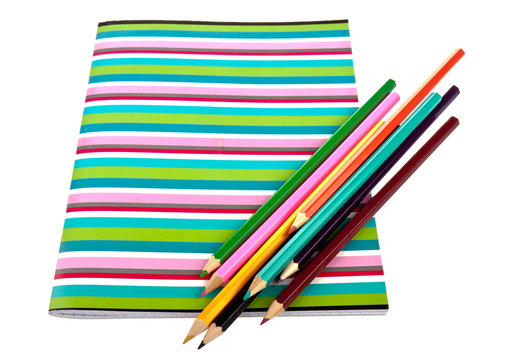 Exercise book with colorful pencils