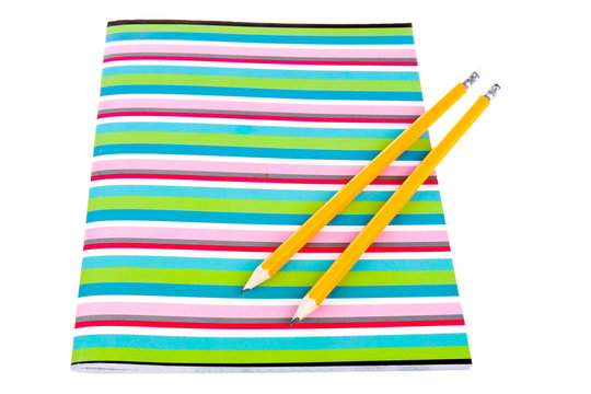 Colorful exercise book with wooden pencils