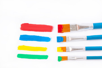 Art brushes in colored inks.On a white background