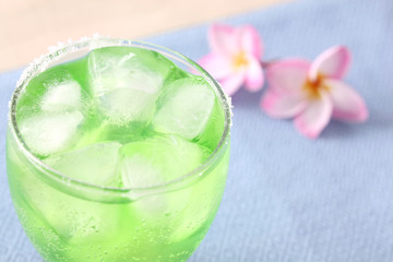 green cocktail with pink flower