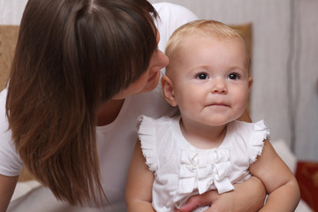Adorable baby and mother in home