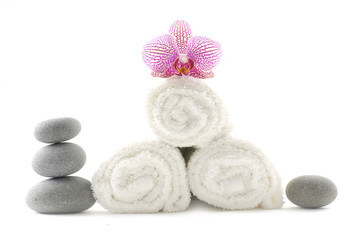 Stone tower with pink orchid on roller towel