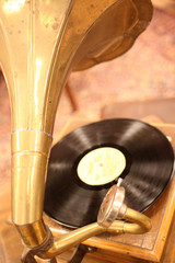 An antique phonograph with vinyl record.
