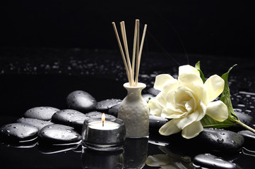 candle with gardenia flower and zen stones