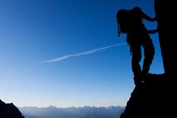 Silhouette of a climber with large copy space