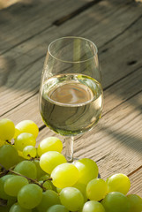 wine and grapes on wooden table
