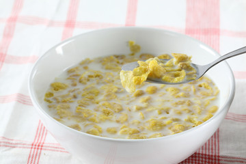Bowl with corn flakes on the white background