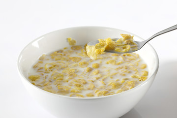 Bowl with corn flakes on the white background
