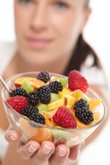woman eating fruit salad