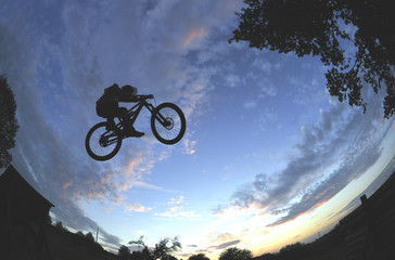 Silhouette of a radical mountain bike jump - 35991525
