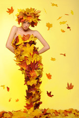 woman in dress of leaves and defoliation