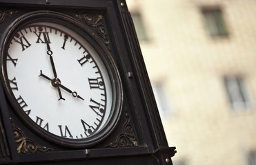 Fototapeta na wymiar Parisian street clock and traffic sign - Paris, France