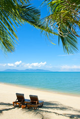 Chairs on the beautiful sandy beach near sea