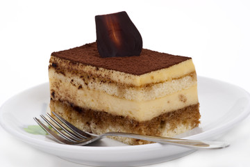 Tiramisu cake on the plate over white background